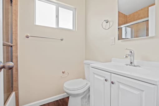 a bathroom with a toilet sink and shower