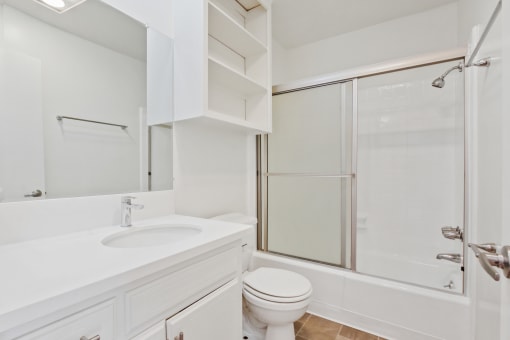 a bathroom with a sink toilet and shower