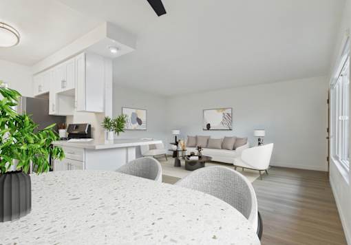 A modern kitchen with a dining table and chairs.