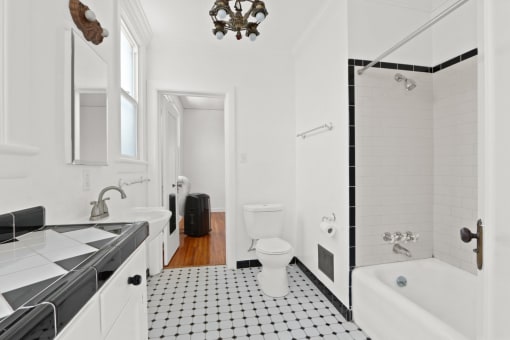 a bathroom with a toilet and a tub and a sink