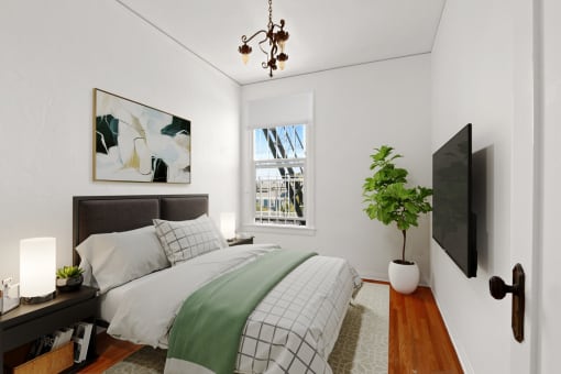 a bedroom with a bed and a large window