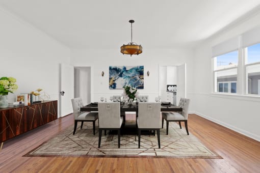 a dining room with a large table and chairs and a rug