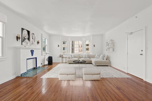 a living room with a white couch and a fireplace