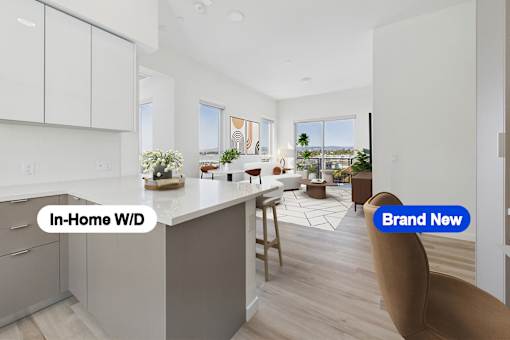 A modern kitchen with a bar stool and a view of the outdoors.