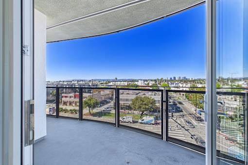 A balcony with a view of a cityscape.