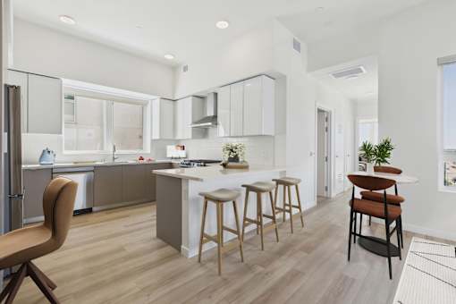 A modern kitchen with wooden floors and furniture.