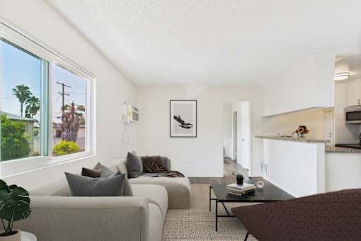 A living room with a couch, a chair, and a coffee table.