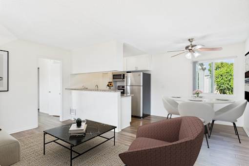 A modern kitchen with a dining table and chairs.