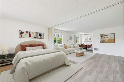 A bedroom with a large bed and a couch.