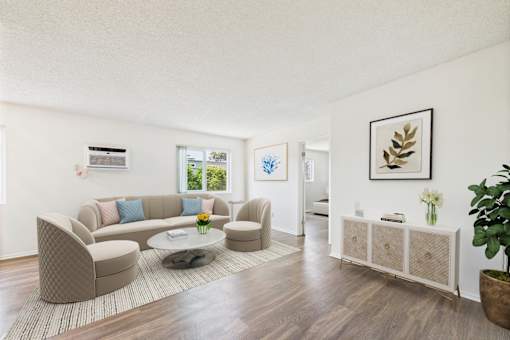 A living room with a brown sofa and a coffee table.