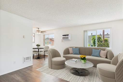 A living room with a couch, chairs, and a coffee table.