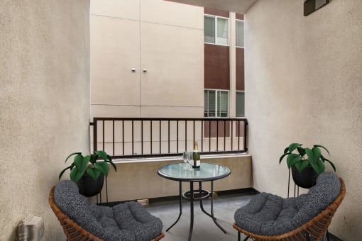 a balcony with two chairs and a table