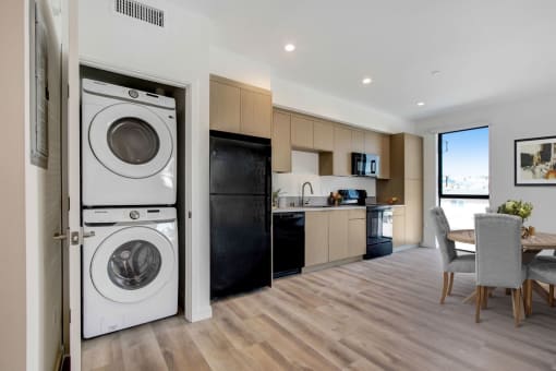 a kitchen and living room with a washer and dryer combo