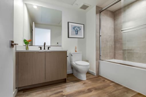 a bathroom with a toilet sink and shower