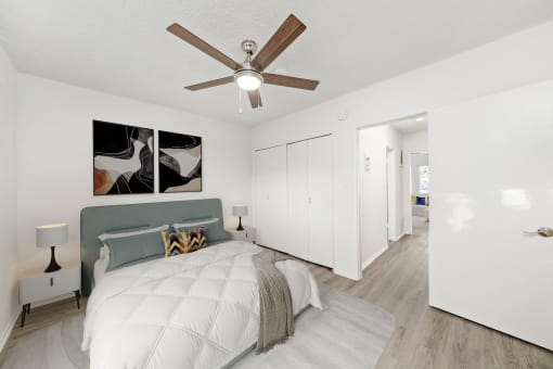 a bedroom with a ceiling fan and a bed