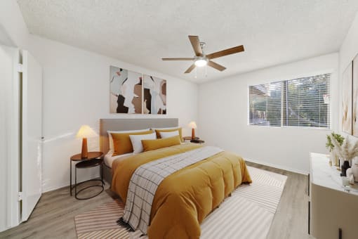 a bedroom with a bed and a ceiling fan
