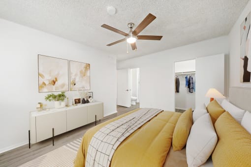 a bedroom with a large bed and a ceiling fan