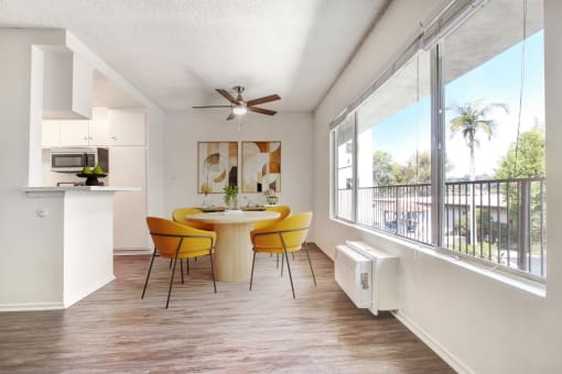 a dining room with a table and chairs and a balcony