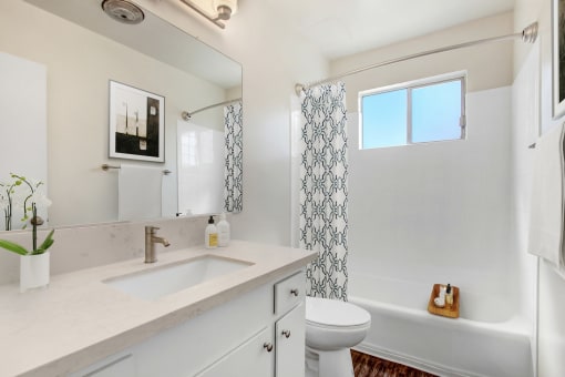 a bathroom with a sink toilet and a shower