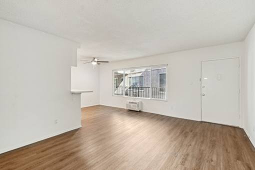 A room with wooden floors and white walls.