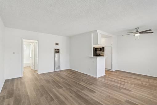 A room with a wooden floor and a ceiling fan.