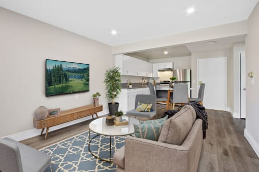 a living room with a couch and a chair in front of a tv