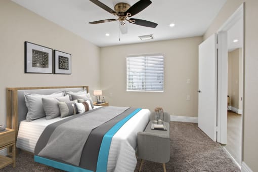 a bedroom with a bed and a ceiling fan