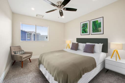 a bedroom with a bed and a ceiling fan