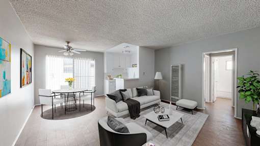 A living room with a white couch, a coffee table, and a painting on the wall.