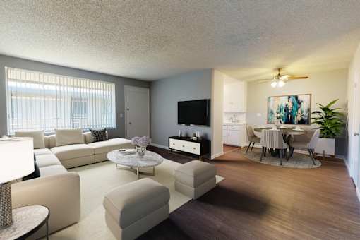 A living room with a white couch and a television.