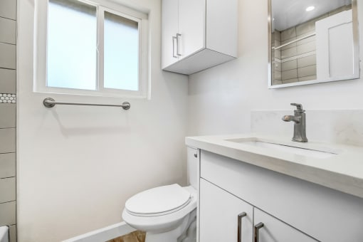 an empty bathroom with a toilet and a sink