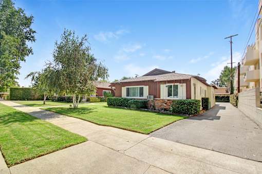 a house with a sidewalk and lawn in front of it