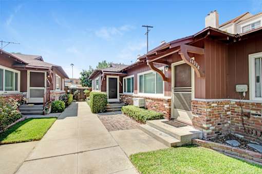 a row of houses with a sidewalk in front of them