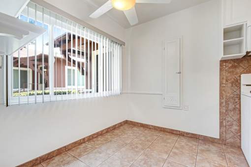 an empty room with a window and a reflection on the wall