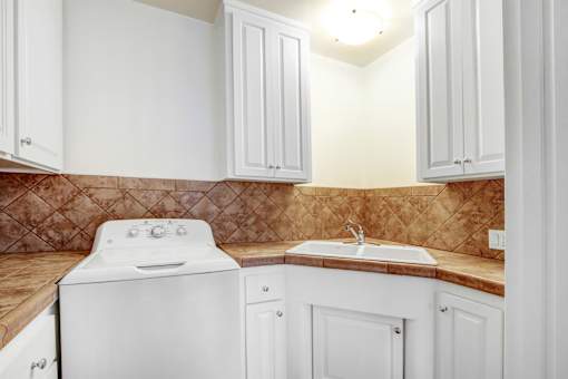 a white kitchen with white appliances and white cabinets