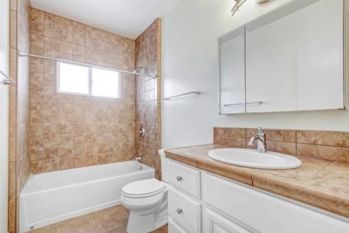a bathroom with a sink toilet and a bath tub