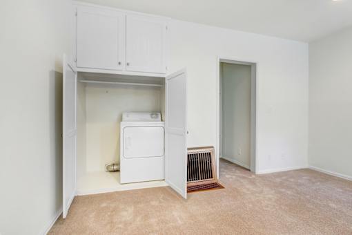 a laundry room with a washer and dryer in it and a closet