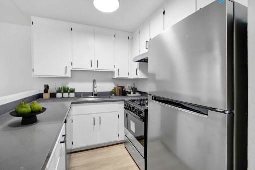 a kitchen with stainless steel appliances and white cabinets