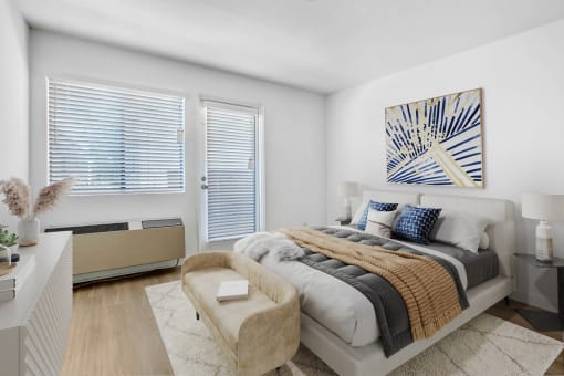 a bedroom with a bed and two windows