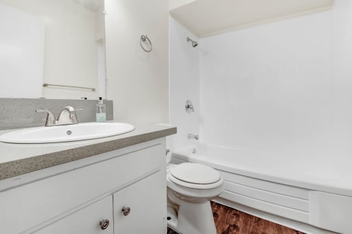 a white bathroom with a sink and a toilet