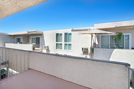 a view of a balcony of a building with an umbrella