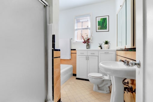 a bathroom with a sink toilet and a bath tub