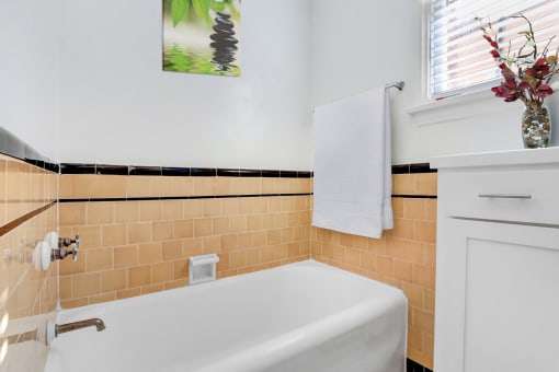 a bathroom with a white tub and a sink