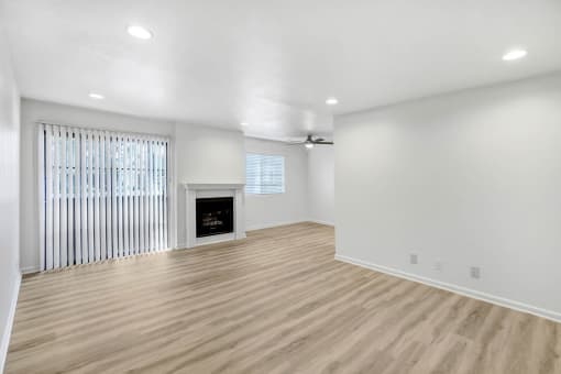 a living room with white walls and a fireplace