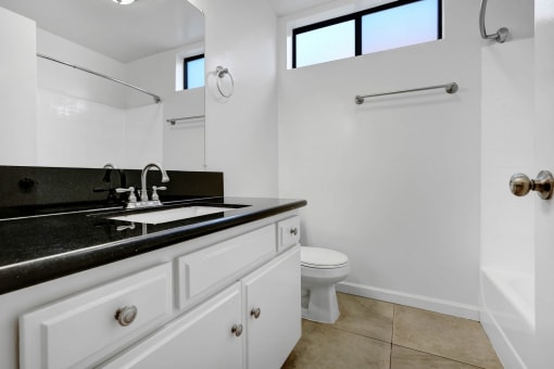 a white bathroom with a sink and a toilet