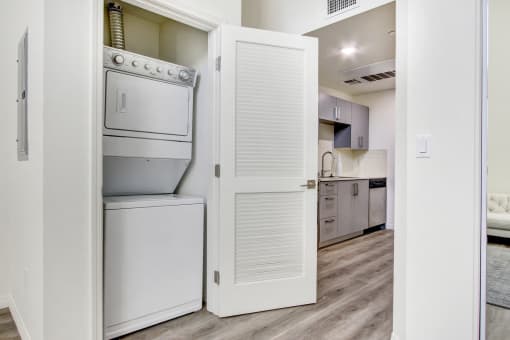In-home Washer and Dryer, wood style floors throughout, kitchen on the right