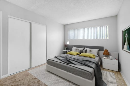 a bedroom with a large bed and a window