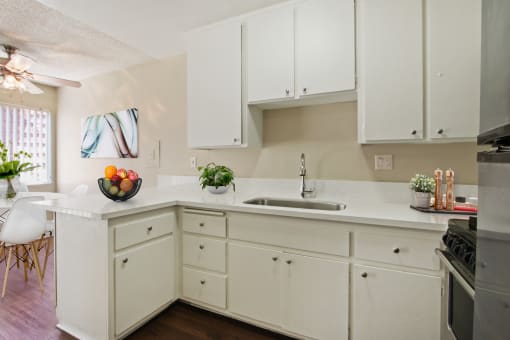 Kitchen With a single sink, small breakfast bar, stainless steel refrigerator