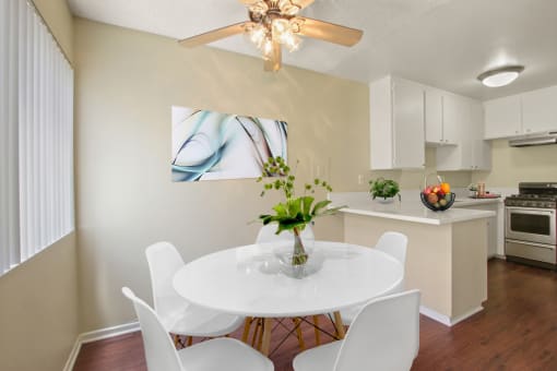 Dining area with ceiliing fan and kitchen on the right