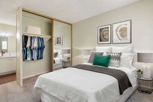 Bedroom with a mirrored closet doors, carpeted floors